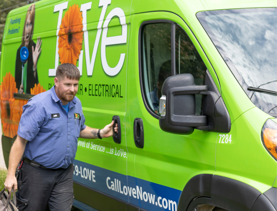 Love Plumbing Air & Electrical technician closing the door on a service van